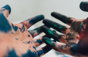 Hands with wet paint on them